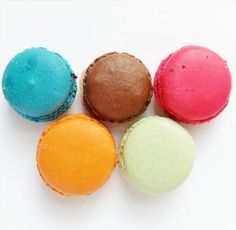 four different colored macaroons sitting next to each other