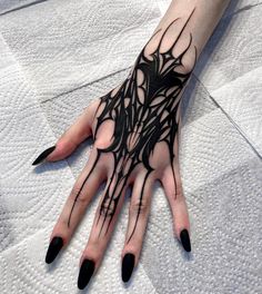 a woman's hand with black and white designs on it