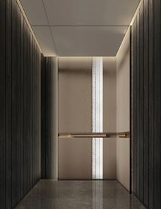 an empty hallway with wooden walls and white trim on the door, leading to another room