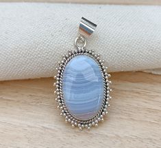 WELCOME AT SILVERDESINGERRING Blue Lace Agate Pendant , 925 Sterling Silver Pendant , Blue Lace Agate Jewellery , Gemstone Pendant, Handmade Pendant, Silver Pendant Wedding METAL - 925 STERLING SILVER  GEMSTONE - BLUE LACE AGATE BENEFITS OF  BLUE LACE AGATE = According to Askinosie, it promotes mood elevation, self-soothing, and a return to a state of serenity. Blue lace agate has a strong connection to the throat chakra because of its blue color. It is good for healing chakras and also helps wi Silver Agate Wedding Jewelry, Bohemian Blue Oval Pendant Jewelry, Blue Pendant Jewelry For Meditation, Blue Adjustable Pendant Crystal Necklace, Blue Agate Dangle Jewelry, Healing Chakras, Blue Lace Agate Jewelry, Jewellery Gemstone, Blue Agate Pendant Jewelry