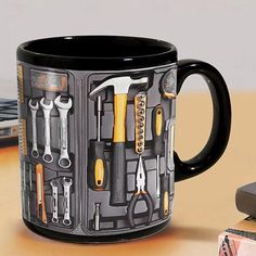 a black coffee mug with tools on it