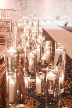 rows of candles are lined up on the table