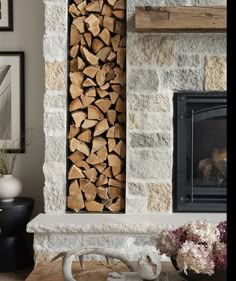 a fire place with logs stacked on top of it next to a fireplace mantel