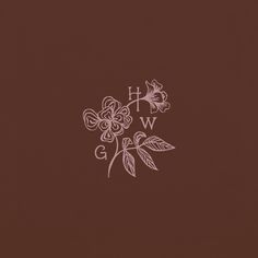 a brown background with white flowers and the letter w on it's left side