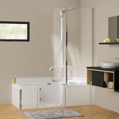 a bath room with a toilet a sink and a shower head mounted to the wall