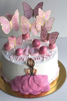 a birthday cake decorated with pink and gold butterflies