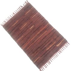 a brown rug with fringes on the top and bottom, against a white background