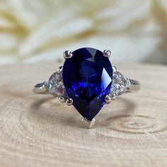 Blue Sapphire Pear Shape Engagement Ring, Blue Sapphire And Moissanite Pear Shape Three Stone Wedding Ring, Sapphire Birthstone Ring #6811 #SeptemberBirthstone #WeddingRing #EngagementRings #PromiseRing #PearShapeRing #AnniversaryGift #SapphireRing #14kGoldRing #EngagementRing #GiftForHer Luxury Sapphire Ring With Prong Setting For Promise, Sapphire Pear Wedding Ring Set, Luxury Teardrop Sapphire Wedding Ring, Luxury Elegant Teardrop Sapphire Ring, Tear Drop Blue Engagement Ring, Blue Sapphire Wedding Ring Giliarto, Luxury Teardrop Sapphire Ring In Elegant Style, Luxury Sapphire Promise Ring For Engagement, Luxury Pear-shaped Sapphire Ring