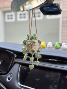 a car dashboard with a stuffed animal hanging from it's rearview mirror