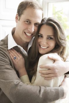 a man and woman are smiling for the camera while holding each other in their arms