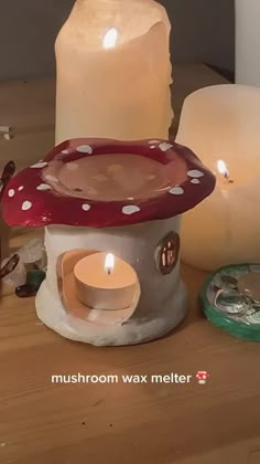 three lit candles sitting on top of a wooden table