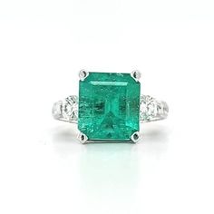 Circa 2000, a 14k white gold, emerald cut emerald and diamond ring, finger size 6.75. This ring features a natural Colombian 4.45cts square emerald cut emerald, measuring 10.72 x 9.94 x 6.67mm. 2 round brilliant cut diamonds total 0.60ctw, these diamonds are H/I color SI2 clarity. Plus an additional 46 round full cut diamonds totaling an estimated 1.04ctw, these diamonds are also H/I color SI2/I1 clarity. Weight is 8.6 grams. Stamped 14k, and hallmarked LLJ. Condition is very good. Thanks for looking. ERA - Circa 2000, Vintage METAL / MATERIAL - 14k white gold MARKINGS / HISTORY - Stamped 14k, and hallmarked LLJ CONDITION - The overall condition is very good! A true representation of 2000s-era jewelry! SIZE / MEASUREMENTS -Size 6.75 / natural Colombian 4.45cts square emerald cut emerald, m Fine Jewelry Emerald Ring With Platinum, Green Octagon Platinum Ring, Platinum Rings With Emerald Cut Gemstone, Octagon Emerald Ring In Platinum, Fine Jewelry, Octagon Emerald Ring In Platinum, Gia Certified Baguette-cut Emerald Platinum Ring, Gia Certified Baguette Cut Emerald Platinum Ring, Octagon Platinum Emerald Ring, Gia Certified Platinum Emerald Baguette Ring