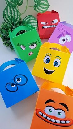 colorful paper bags with cartoon faces on them