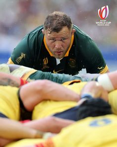 a rugby player is being tackled by two other players