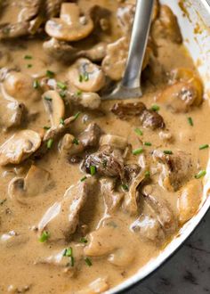 a bowl full of mushroom soup with a spoon in it