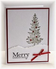 a white christmas card with a red ribbon on the bottom and a tree in the middle