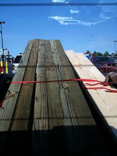 large wooden planks are tied to the back of a truck