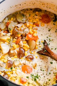 a pot filled with corn and potatoes on top of a stove