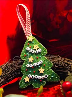 a green christmas tree ornament sitting on top of a table