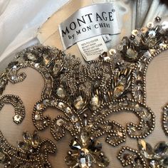 the back of a dress that is covered in jewels and sequins, with a label on it