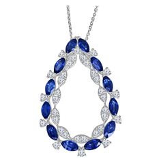 At the outside of this pendant, 12 marquise-cut blue sapphires playfully alternate with 11 round diamonds, creating a captivating dance of color and sparkle. The sapphires symbolize wisdom and royalty, while the diamonds represent purity and eternity. This combination brings a perfect balance of vibrancy and brilliance. Within the inner inner frame, pairs of round diamonds create a marquise illusion effect. The pendant's design is not just visually stunning; it's also a testament to precision an Blue Sapphire Round Cut Necklace, Sapphire Diamond Necklace, Round Diamond Pendant, White Gold Pendant Necklace, Vintage Pendant Necklace, Antique Pendant, Sapphire Pendant, Antique Necklace, Pearl Pendant Necklace