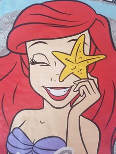 a drawing of a mermaid holding a starfish in her right hand and smiling at the camera