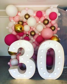 the number 30 is surrounded by balloons and gold balls in pink, white, and grey colors