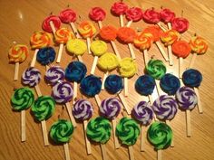 several lollipops are arranged on wooden sticks