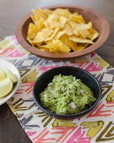 guacamole and chips on a colorful table cloth