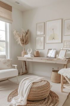 a living room with white furniture and pictures on the wall above it's desk