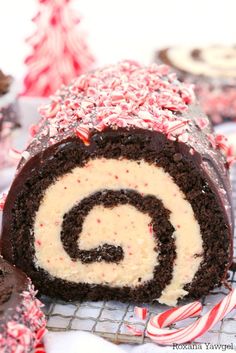 a chocolate roll with white frosting and peppermint sprinkles on top