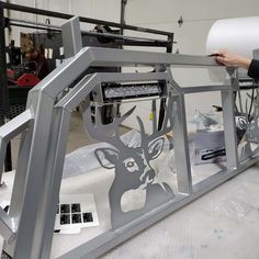 a person is working on a machine in a factory with paper and other items surrounding it