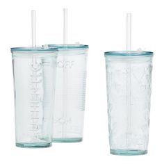 three clear tumblers with straws and lids are lined up on a white background