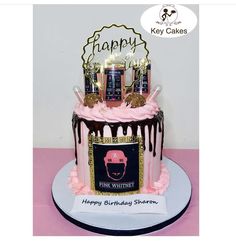 a birthday cake with pink frosting and chocolate icing on top, decorated with candles