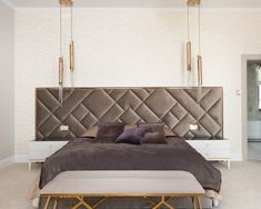 a bedroom with a large bed and gold headboard