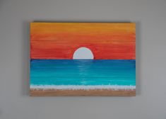 an orange and blue painting hangs on the wall