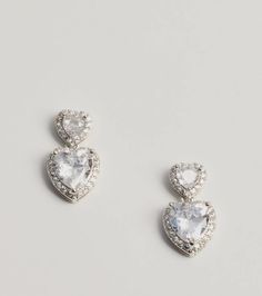 pair of heart shaped earrings with crystal stones on the sides and white crystals in the middle