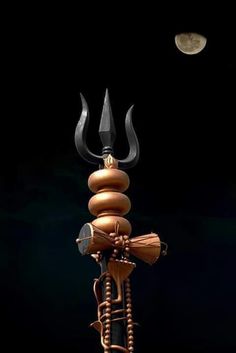 an artistic image of a candle holder made out of wood and metal with two horns on top