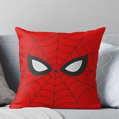 a red spider - man face with white eyes on it's chest throw pillow