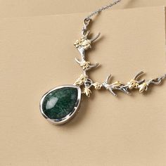 Unveil elegance with this green aventurine necklace, a fusion of artistry and natural allure. Crafted in 18K yellow gold plated brass and stainless steel, this 18-inch green aventurine drop necklace features a bezel-set aventurine pendant&nbsphung&nbspon a stainless steel chain. The pendant, adorned with a V-shaped floral vine, adds a touch of timeless charm to any ensemble.       Details        Drop pendant for women Floral vine theme V-shape frame Pear-shaped aventurine&nbspdrop in&nbspcenter Exhibits vibrant green hues Bezel setting for secure gemstone placement 18-inch stainless steel chain for durability 18K yellow gold plated brass adds lustrous appeal Hypoallergenic metal crafting Lobster clasp security Smooth under gallery Perfect for adding a pop of color to your outfit Green Aventurine Necklace, Aventurine Necklace, Pendant For Women, Green Hues, Floral Vine, Sweat Proof, Vibrant Green, Drop Necklace, Drop Pendant