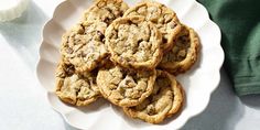 a white plate topped with cookies next to a glass of milk