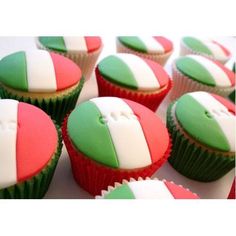 cupcakes with green, white and red frosting on top of each other