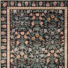 an antique rug with flowers and leaves on it