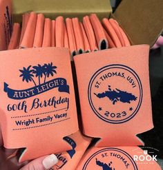 pink and blue napkins with palm trees on them in a cardboard box for sale