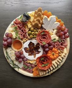 a plate filled with lots of different types of cheese and meats on top of each other