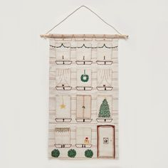 a white wall hanging with christmas decorations on it