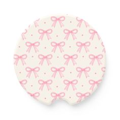 a pink and white plate with bows on it