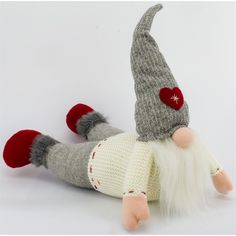 a knitted gnome doll laying on its back