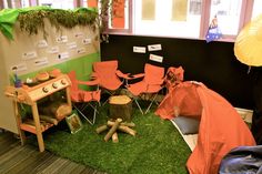 an office cubicle with chairs, tables and umbrellas on the green carpeted floor