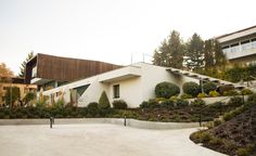 a white house surrounded by trees and bushes